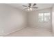 Neutral bedroom with a ceiling fan and a bright window at 9537 Michelle Falls Ave, Las Vegas, NV 89149