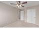 Standard bedroom with a ceiling fan and double closet at 9537 Michelle Falls Ave, Las Vegas, NV 89149