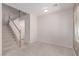 Light-filled bonus room featuring neutral walls, carpet and stairs leading to the second floor at 9537 Michelle Falls Ave, Las Vegas, NV 89149
