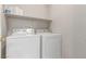 Functional laundry room with modern side-by-side washer and dryer at 9537 Michelle Falls Ave, Las Vegas, NV 89149