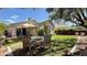 Spacious backyard with a covered patio, dining set, and well-maintained lawn, perfect for outdoor entertaining at 988 Upper Meadows Pl, Henderson, NV 89052