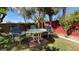 Lush backyard with a cozy outdoor dining set surrounded by mature trees and greenery at 988 Upper Meadows Pl, Henderson, NV 89052