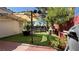 Landscaped backyard with covered patio, BBQ grill, and lush greenery at 988 Upper Meadows Pl, Henderson, NV 89052