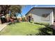 Expansive backyard with a lush lawn, garden beds, a pergola, and a private, serene atmosphere at 988 Upper Meadows Pl, Henderson, NV 89052