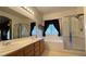 Bright bathroom features double sinks, soaking tub, and glass enclosed shower at 988 Upper Meadows Pl, Henderson, NV 89052