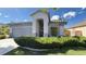 Inviting home with a tile roof, arched entryway, lush front yard, and a gray exterior at 988 Upper Meadows Pl, Henderson, NV 89052