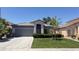 Charming single-story home with a well-maintained lawn and two-car garage at 988 Upper Meadows Pl, Henderson, NV 89052