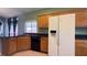 The kitchen features wood cabinets, dark countertops, tile flooring, and modern appliances at 988 Upper Meadows Pl, Henderson, NV 89052