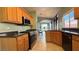 Practical kitchen featuring updated appliances, tile floor, and granite countertops at 988 Upper Meadows Pl, Henderson, NV 89052