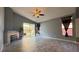 Bright living room with tile flooring, fireplace, and sliding glass doors leading to backyard at 988 Upper Meadows Pl, Henderson, NV 89052