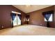 Spacious main bedroom with carpet, a ceiling fan, and direct access to the outdoor patio at 988 Upper Meadows Pl, Henderson, NV 89052