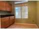 The pantry features cabinets, a dark countertop, a window and tile flooring at 988 Upper Meadows Pl, Henderson, NV 89052