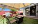 Cozy outdoor patio with grill, fire pit, and seamless indoor-outdoor flow through sliding glass doors at 988 Upper Meadows Pl, Henderson, NV 89052