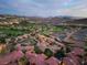 Wide aerial shot of houses with red roofs in a golf course community with mountain views at 1 Cerchio Basso, Henderson, NV 89011