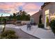 Backyard featuring stone pavers, an outdoor seating area, mature trees, and privacy at 1 Cerchio Basso, Henderson, NV 89011