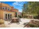 Backyard with a large round table and comfortable seating perfect for outdoor living at 1 Cerchio Basso, Henderson, NV 89011