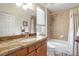 Well-lit bathroom featuring granite counters, tub, shower, and modern fixtures at 1 Cerchio Basso, Henderson, NV 89011