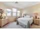 Neutral bedroom with a large bed, three windows and bedside tables at 1 Cerchio Basso, Henderson, NV 89011
