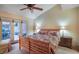 Cozy bedroom with French doors to patio, a ceiling fan, and warm lighting at 1 Cerchio Basso, Henderson, NV 89011