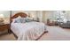 Spacious bedroom featuring a queen-sized bed and sitting area by a bright window at 1 Cerchio Basso, Henderson, NV 89011