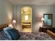 Bedroom featuring an ensuite bathroom through an arched doorway with vanity and bath at 1 Cerchio Basso, Henderson, NV 89011