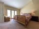 Cozy bedroom with high ceilings, neutral tones, and a sitting area near the patio doors at 1 Cerchio Basso, Henderson, NV 89011