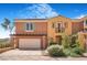 Charming townhome featuring stucco siding, an attached two-car garage, and well-manicured landscaping at 1 Cerchio Basso, Henderson, NV 89011
