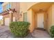 Inviting front entrance of townhome with manicured shrubbery and covered parking at 1 Cerchio Basso, Henderson, NV 89011