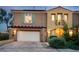 Two-story house with a large garage, balcony, and manicured landscaping at 1 Cerchio Basso, Henderson, NV 89011