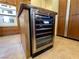 Kitchen island featuring a modern wine fridge and views of the double ovens at 1 Cerchio Basso, Henderson, NV 89011