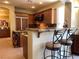 Well-equipped kitchen with wooden cabinets, granite countertops, and barstool seating at the island at 1 Cerchio Basso, Henderson, NV 89011