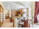 Kitchen with barstool seating and stainless steel appliances with custom wood cabinets at 1 Cerchio Basso, Henderson, NV 89011