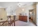 Bright upstairs landing with wood banister and view into the bedroom at 1 Cerchio Basso, Henderson, NV 89011