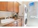 Laundry room with stacked washer and dryer next to sink at 1 Cerchio Basso, Henderson, NV 89011