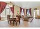 Elegant living room with large windows and a formal dining area at 1 Cerchio Basso, Henderson, NV 89011
