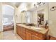 Bathroom featuring double sinks with granite countertops, and adjacent closet space at 1 Cerchio Basso, Henderson, NV 89011