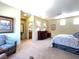 Spacious main bedroom suite with sitting area, carpet floors and access to a bathroom at 1 Cerchio Basso, Henderson, NV 89011