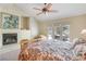 Comfortable bedroom with a fireplace, ceiling fan, and access to the outdoor patio at 1 Cerchio Basso, Henderson, NV 89011