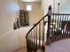 Elegant staircase with wood railing leads upstairs, offering a glimpse of the home's layout at 1 Cerchio Basso, Henderson, NV 89011