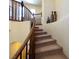 Detailed view of the staircase with carpeted steps, wooden railing, and art niches at 1 Cerchio Basso, Henderson, NV 89011