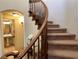 Close-up of a carpeted staircase with a wooden railing, showcasing the home's design at 1 Cerchio Basso, Henderson, NV 89011