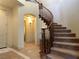 Grand staircase with carpeted steps and wooden railing, leading to upper level at 1 Cerchio Basso, Henderson, NV 89011
