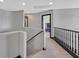 Upstairs hallway with carpet floors, decorative trim, and access to multiple bedrooms at 1020 High Altitude Ave, North Las Vegas, NV 89032