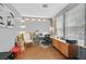 Well-lit home office with a large desk, comfortable seating, and plenty of natural light from the bright windows at 1020 High Altitude Ave, North Las Vegas, NV 89032