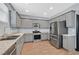 Well-equipped kitchen featuring stainless steel appliances, gray cabinetry, and granite countertops at 1020 High Altitude Ave, North Las Vegas, NV 89032