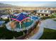 Aerial view of the community park featuring a playground, splash pad, pool, walking trails, and green spaces at 10324 Stroma Ave, Las Vegas, NV 89166