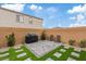 Outdoor view highlighting the backyard with paver patio, grill, and grass squares at 10324 Stroma Ave, Las Vegas, NV 89166