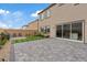 Multi-story back exterior showing grass squares and a large paved patio area at 10324 Stroma Ave, Las Vegas, NV 89166