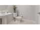 Bright powder room featuring a pedestal sink, toilet, and neutral-toned walls at 10324 Stroma Ave, Las Vegas, NV 89166