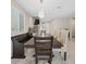 Bright dining room with chandelier, stairs to the second level and a large window at 10324 Stroma Ave, Las Vegas, NV 89166